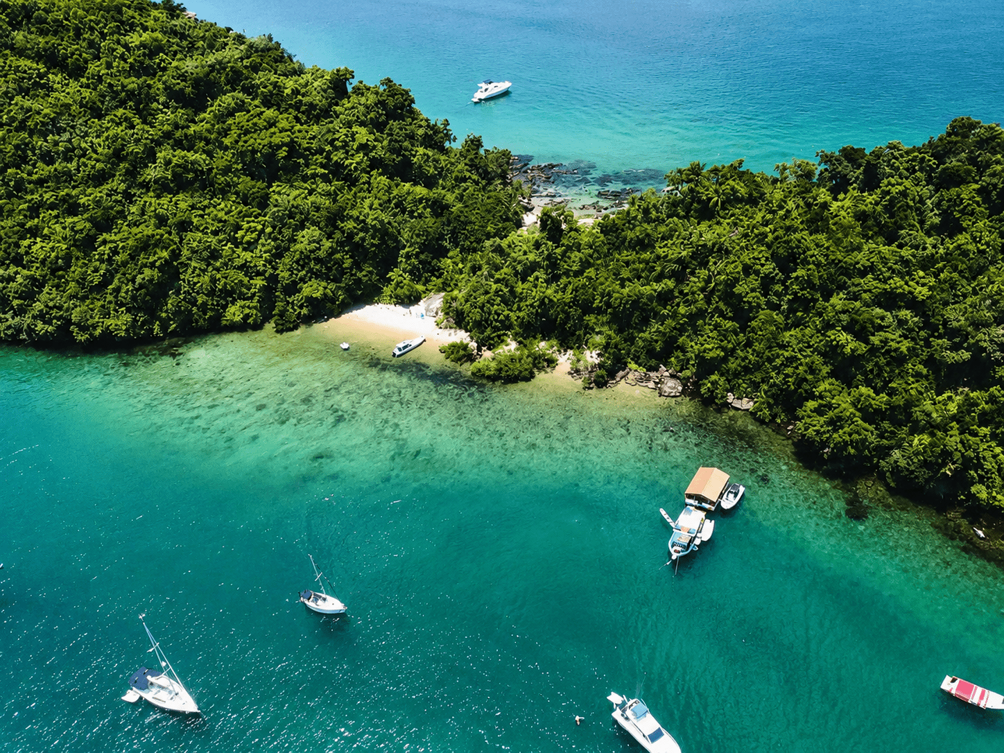 Tropical coastline and overnight yacht charter setting in Paraty